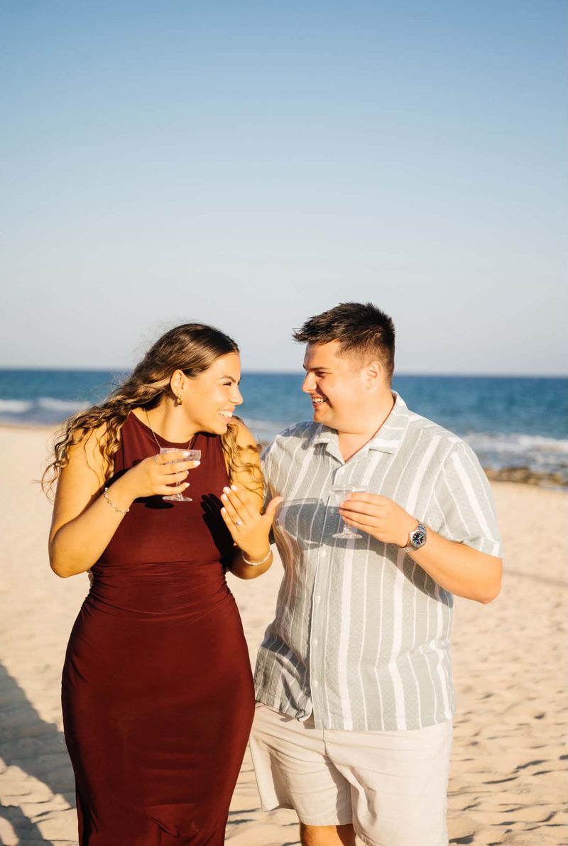 Liam down on one knee on the sand